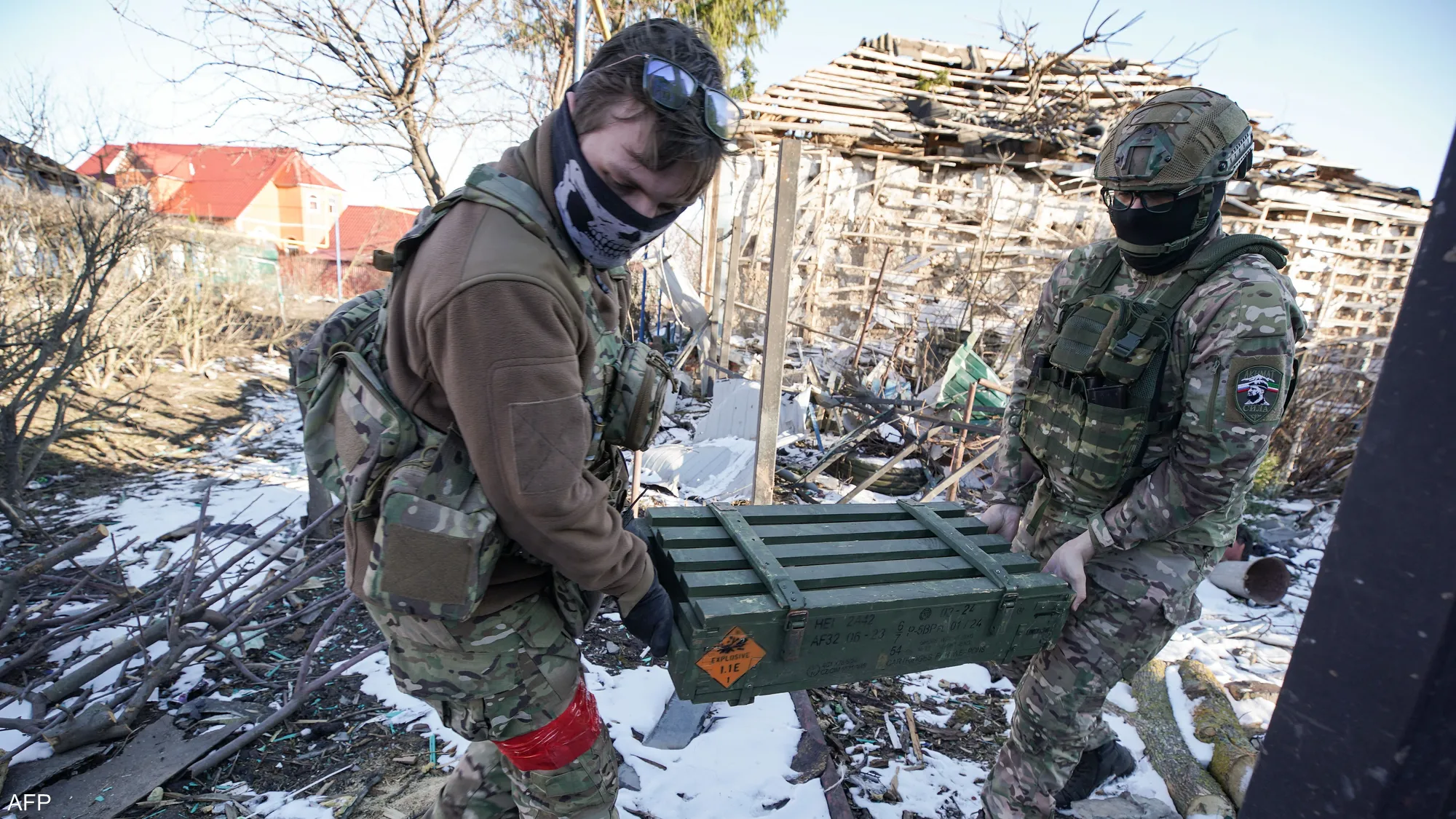Two Russian soldiers transport ammunition on one of the front-line sectors in Ukraine, in a scene reflecting ongoing logistical support for active combat operations on the battlefield.