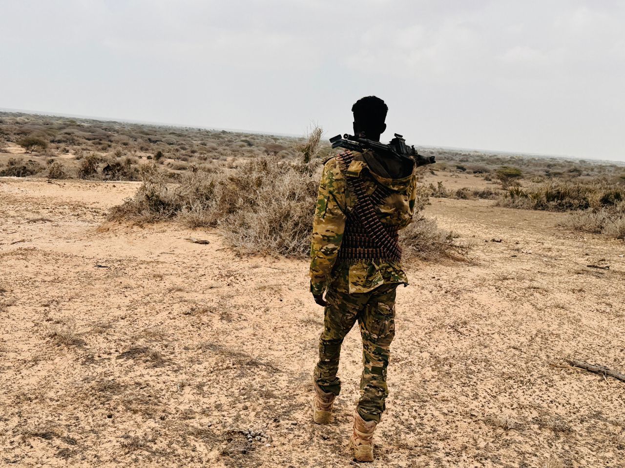 Somali National Army soldier conducts a patrol while monitoring the surrounding area for security.