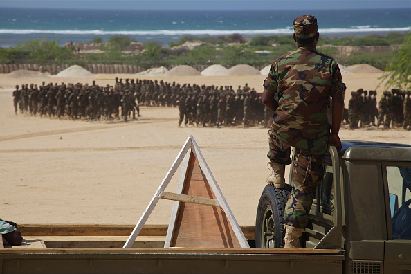 A Somali soldier watches as new recruits for the Somali National Army marches at the passing out parade at Al Jazeera training camp in Mogadishu. 14 August 2012 (Photo by Noe Falk Nielsen/NurPhoto via Getty Images)