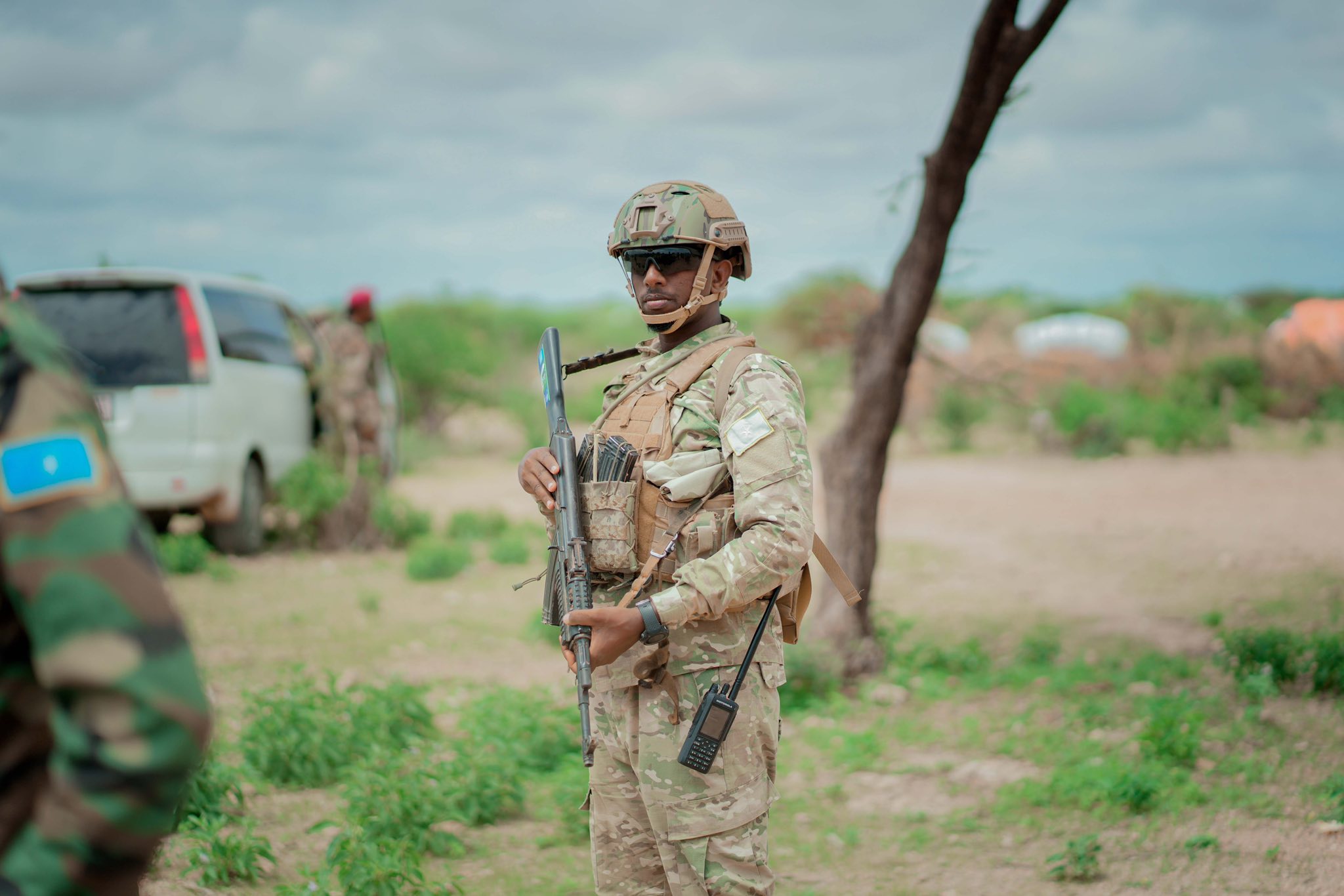 A Somali National Army soldier holding an AK-47 rifle during a field operation, standing alert in a secured area as part of ongoing counterterrorism efforts in southern Somalia.