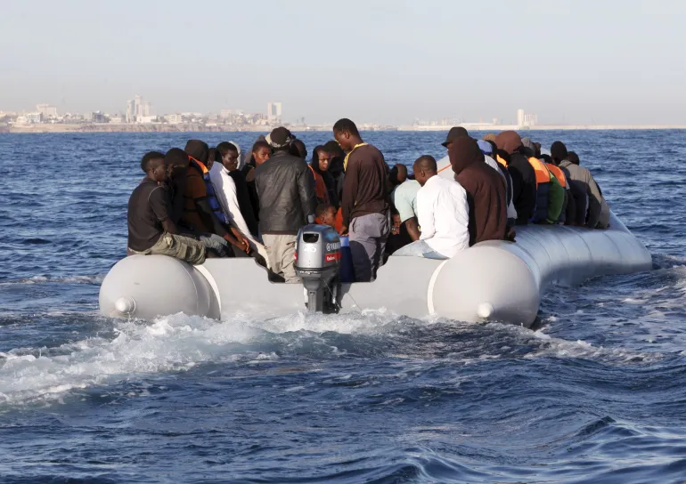 Migrants on an inflatable boat in the Mediterranean Sea attempting to reach Europe.