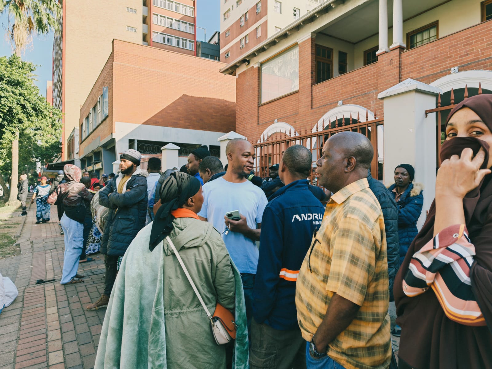 Migrants gather at a temporary shelter in Durban, South Africa, following an evacuation operation amid anti-migrant tensions and rising pressure on foreign nationals in the area.