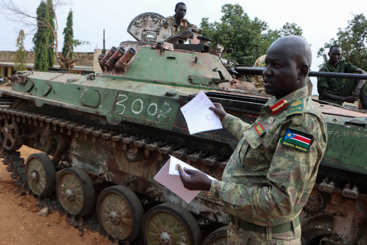 Left: Major General Lul Ruai Koang the spokesperson for the South Sudan People's Defence Forces (SSPDF) shows journalists a captured BMP-2 infantry fighting vehicle nicknamed "Boorchar" seized by Sudan People's Liberation Movement-in-Opposition (SPLA-IO) fighters from an Indian peacekeeping unit serving under the United Nations Mission in South Sudan (UNMISS) during the 2013 conflict; after a press conference on the military operations in Akobo and ordering the withdrawal of UNMISS from the area; at the SSPDF armory barracks in Juba, South Sudan, March 6, 2026. Photo by Samir Bol/Reuters