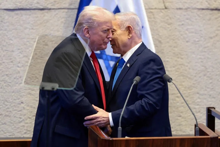 US President Donald Trump and Israeli Prime Minister Benjamin Netanyahu are seen at the Israeli Knesset in October 2025 [Evelyn Hockstein/Reuters]
