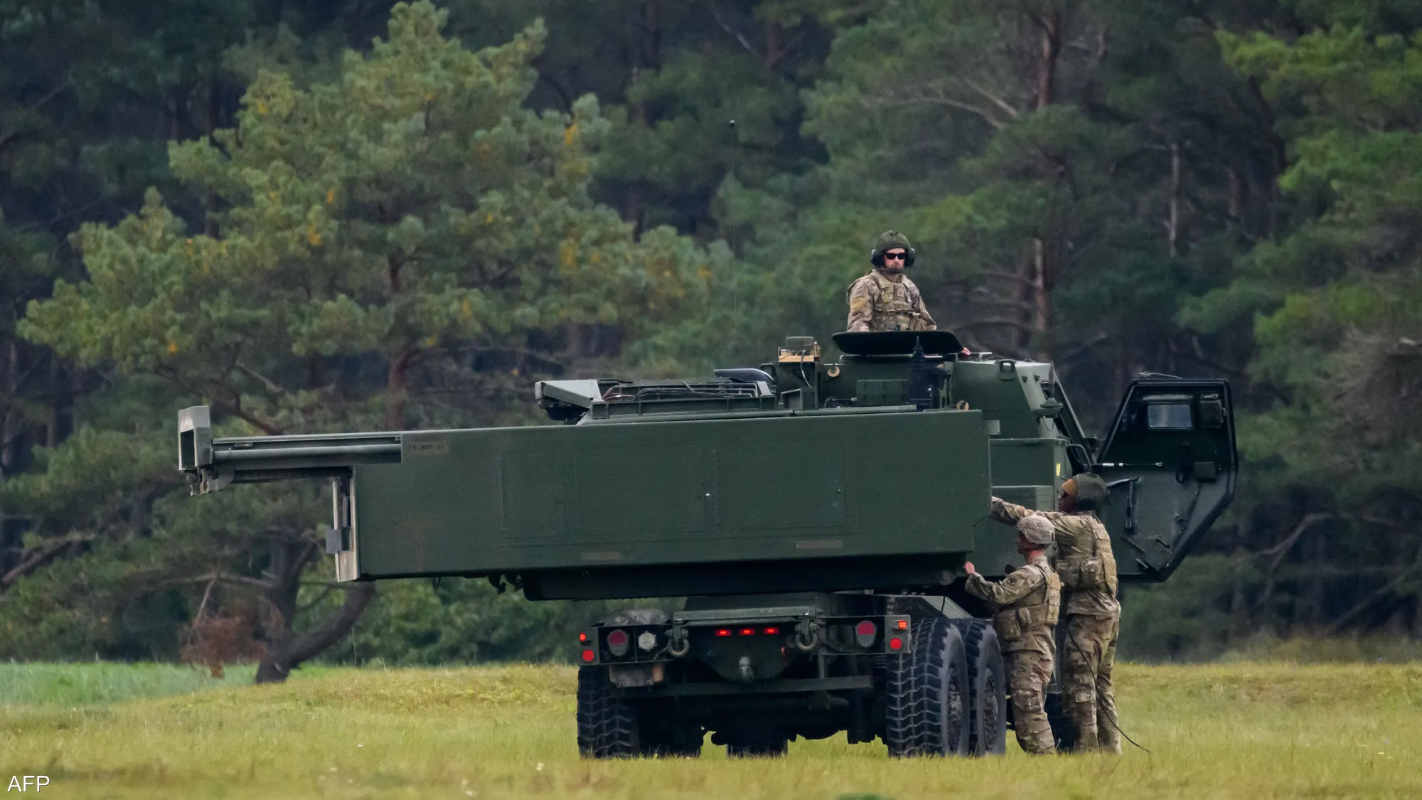 U.S. Marines operate a HIMARS mobile rocket launcher during a live-fire training exercise near Mount Fuji, Japan, firing precision rockets as part of a rapid deployment readiness drill.