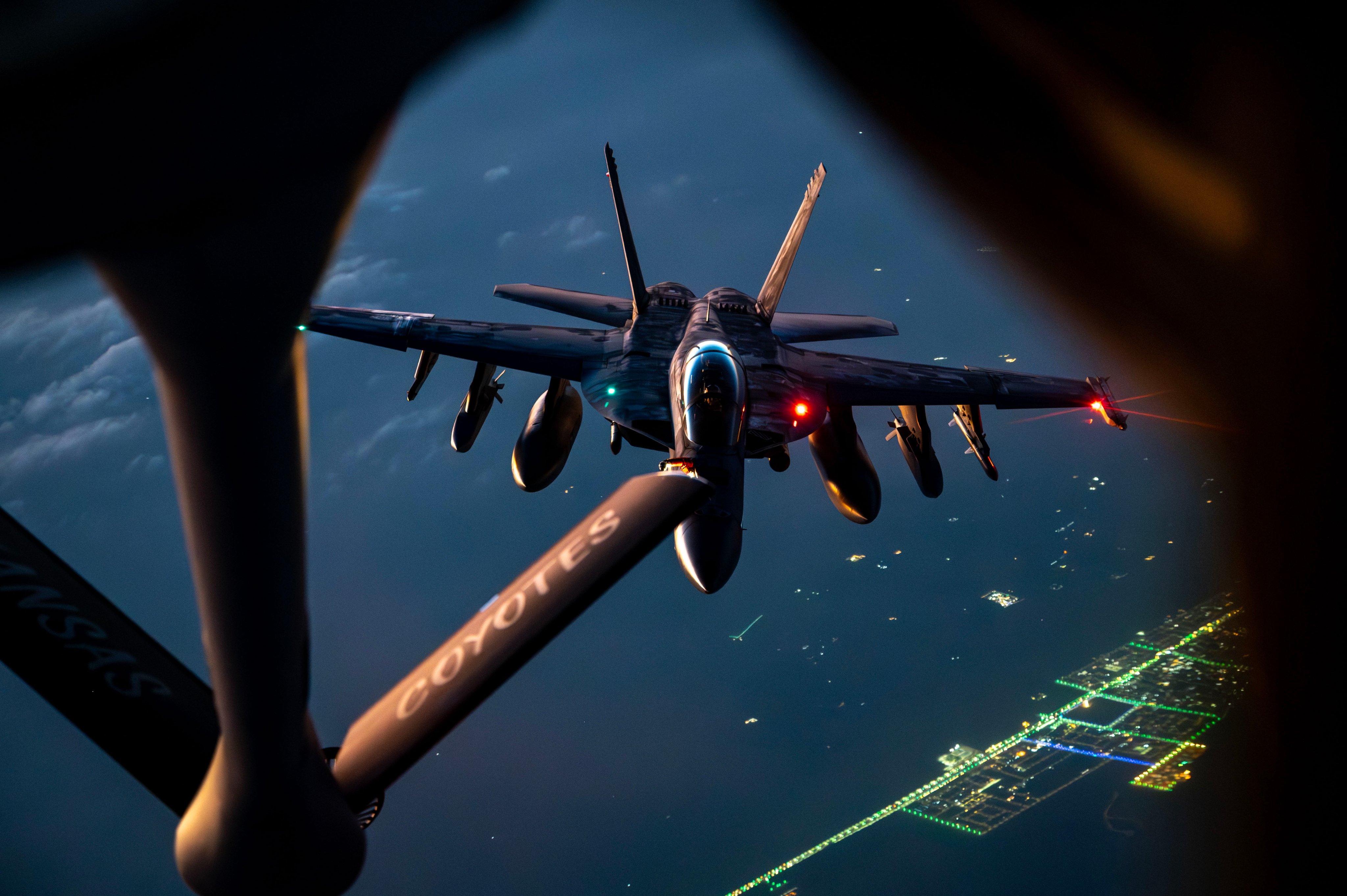 A U.S. Air Force KC-135 Stratotanker refuels a U.S. Navy F/A-18F Super Hornet over the middle east during Operation Epic Fury.