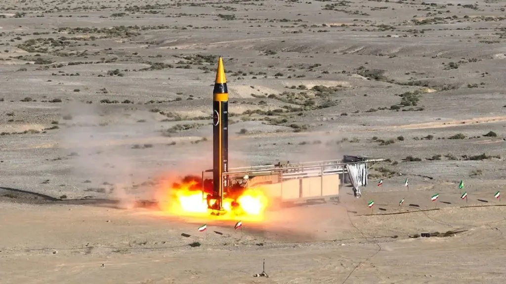 Iran launches multiple missiles toward Israel, smoke trails visible over northern cities.