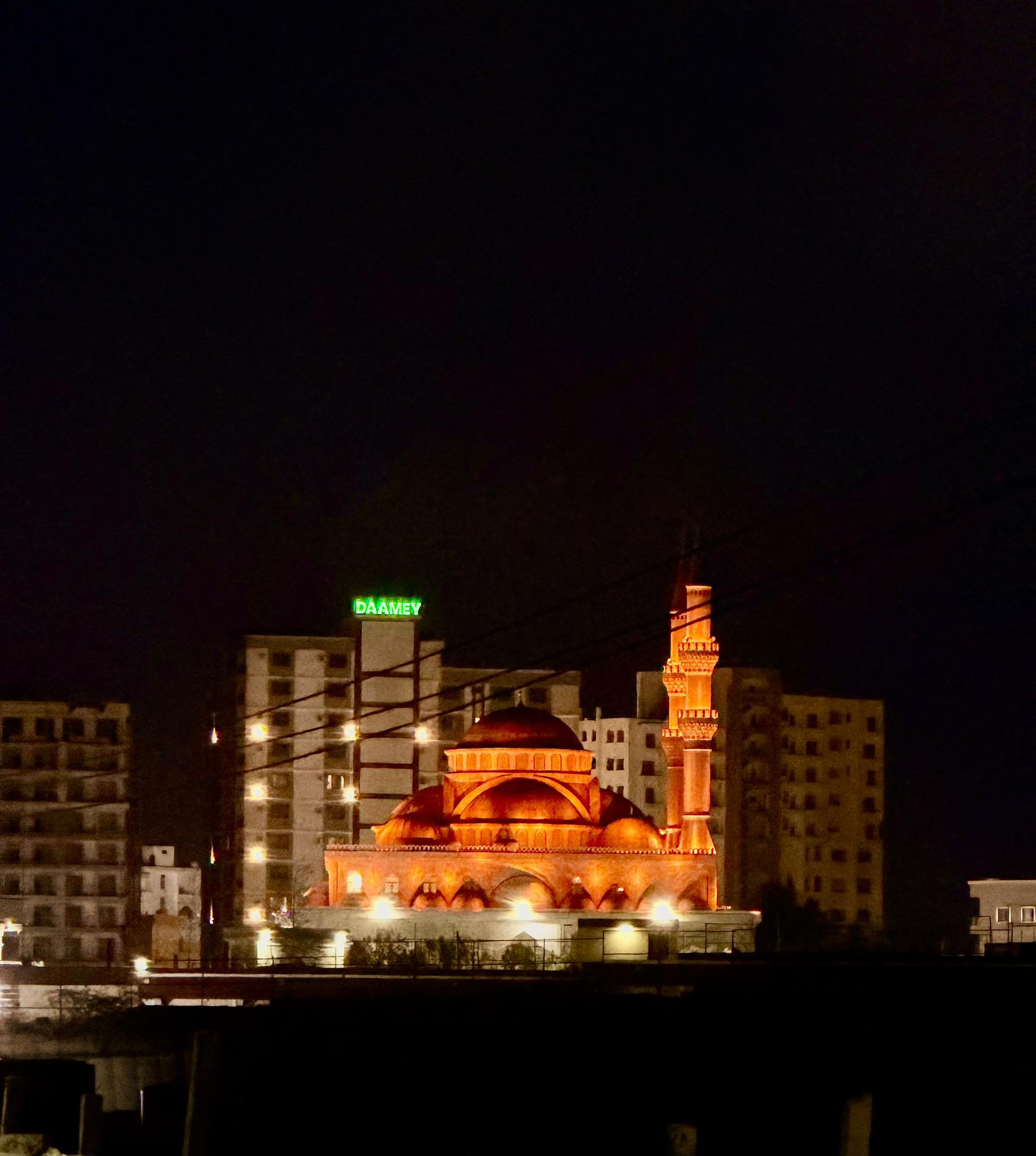 A view of Mogadishu, Somalia's capital, featuring the Ali Jimale Mosque and towering skyscrapers in the background.