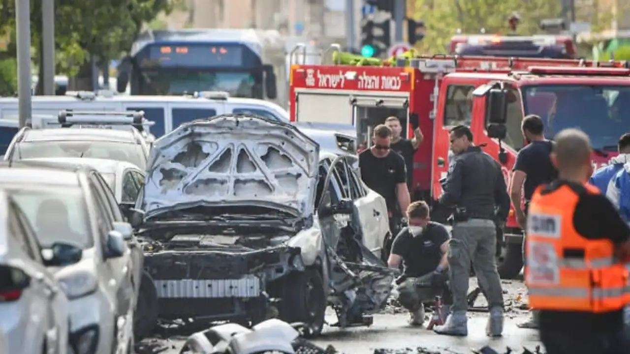Israeli police secure the scene after deadly car explosions and shootings in central Israel that killed five people.