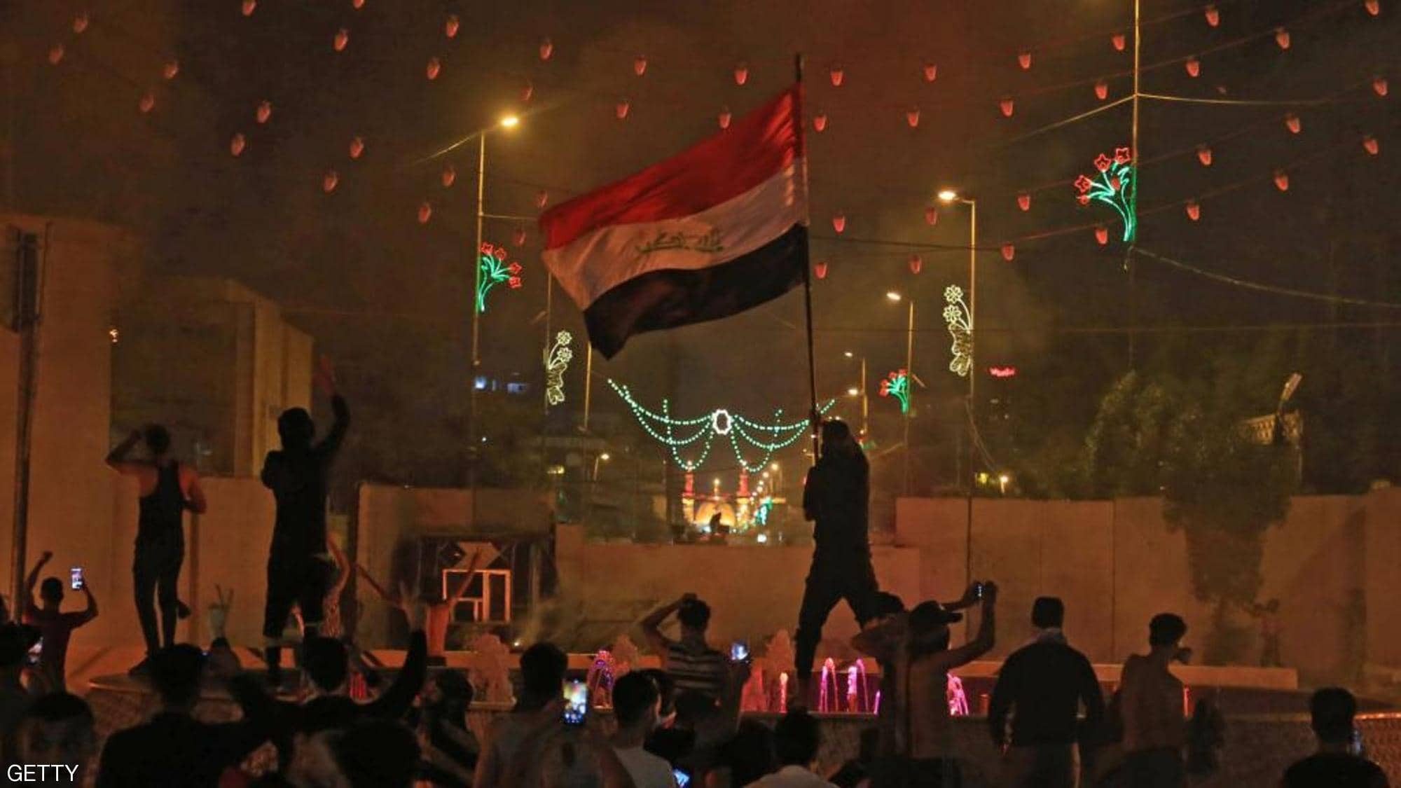 Iraqi protesters surround the Iranian consulate in Karbala.