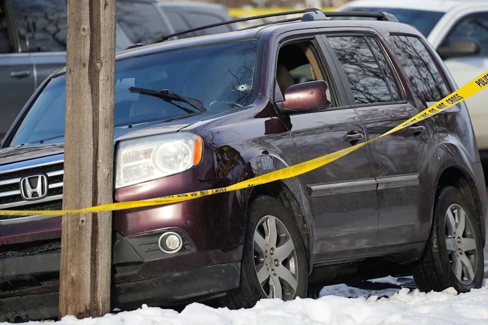 Tim Evans/Reuters - PHOTO: Police tape is seen around a vehicle with a bullet hole the windshield after a driver was shot in Minneapolis, on Jan. 7, 2026.