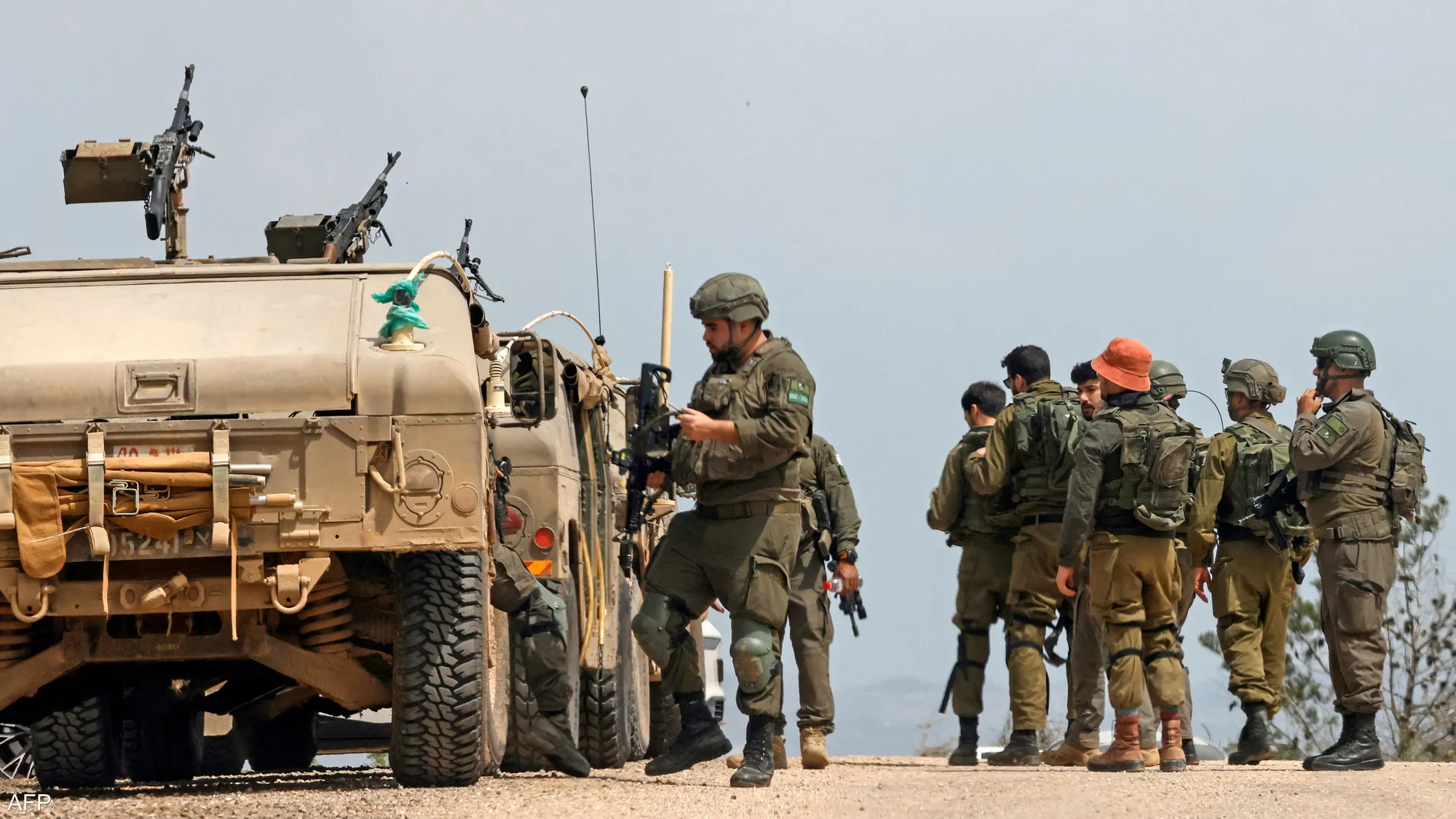 Armed Israeli troops advance through a southern Lebanese area during ongoing military operations near the border.