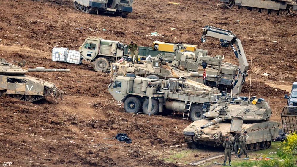 Israeli tanks advance near the Lebanon border amid rising tensions.