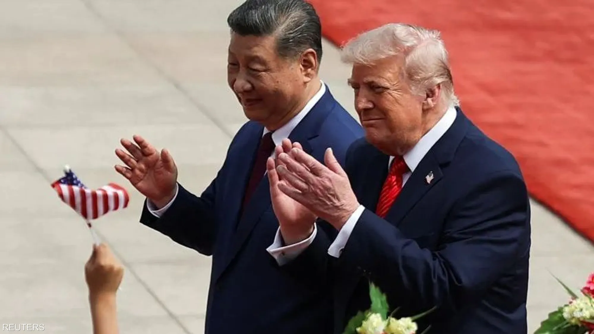 U.S. President Donald Trump walks alongside Chinese President Xi Jinping in Beijing following an official reception ceremony ahead of bilateral talks on trade and global security issues.