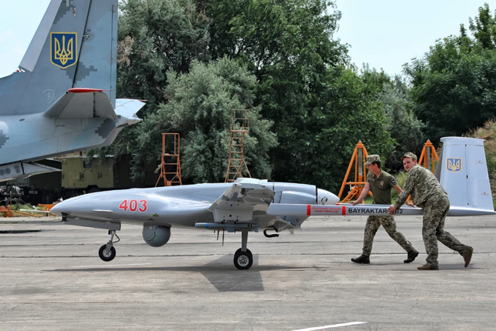 Soldiers push a Bayraktar TB2 drone on a tarmac in southern Ukraine during an exercise in 2021. Nina Liashonok/Getty Images