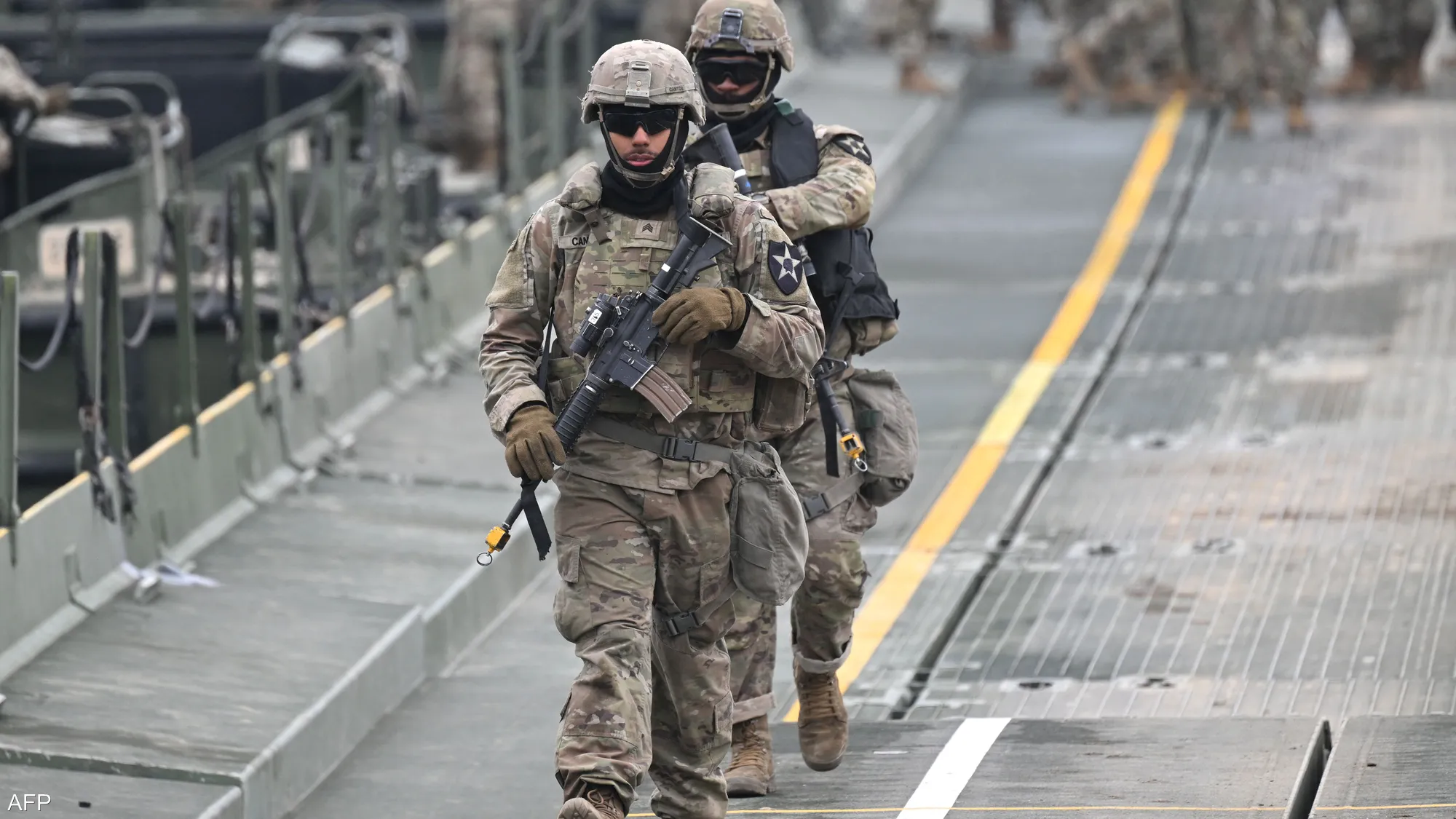 U.S. forces walk through a military facility as operations continue during the ongoing "Epic Rage" campaign and heightened security tensions in the Strait of Hormuz.