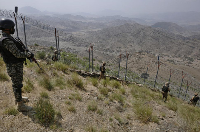 Pakistan Army troops patrol along the fence on the Pakistan Afghanistan border at Big Ben hilltop post in Khyber district, Pakistan, Tuesday, Aug. 3, 2021. (AP)