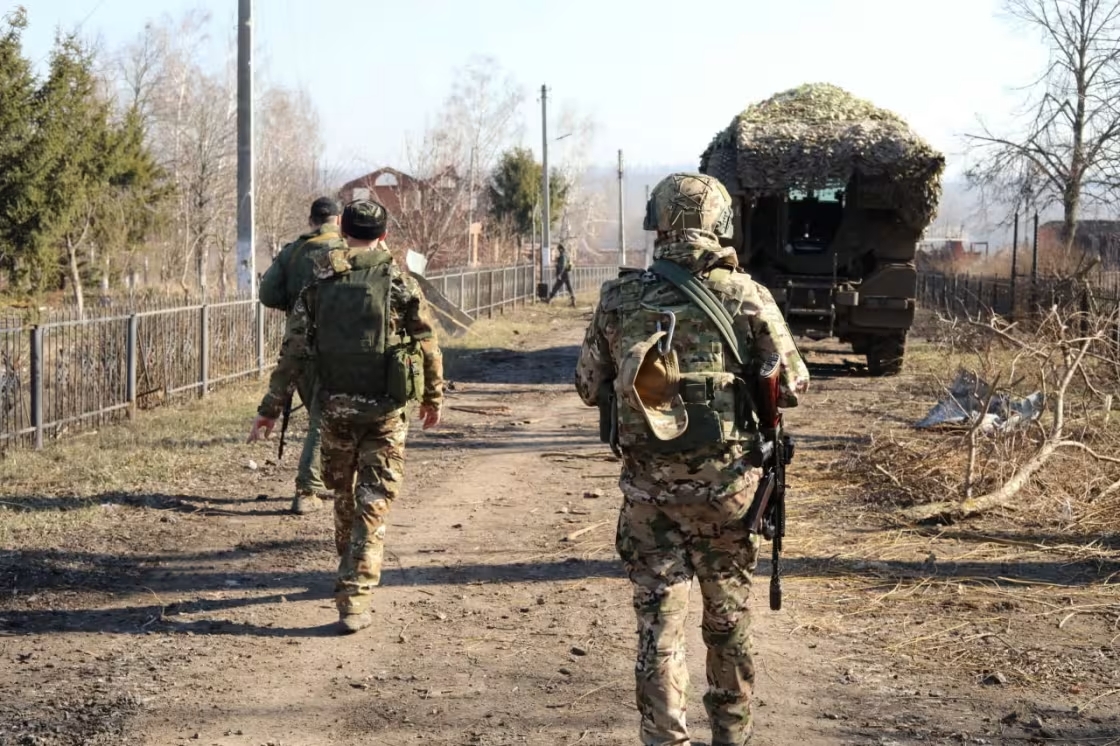 Russian service members walk along a street in a part of the Kursk region which was recently retaken by Russia's armed forces / Russian Defence Ministry via Reuters.