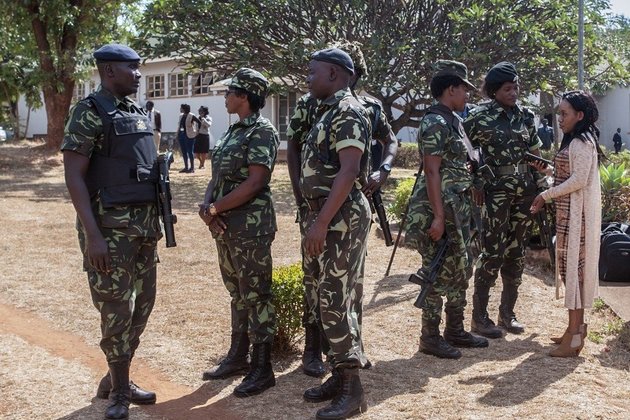 Malawi Police Service paramilitary officers in camouflage uniforms patrol during a public order operation.