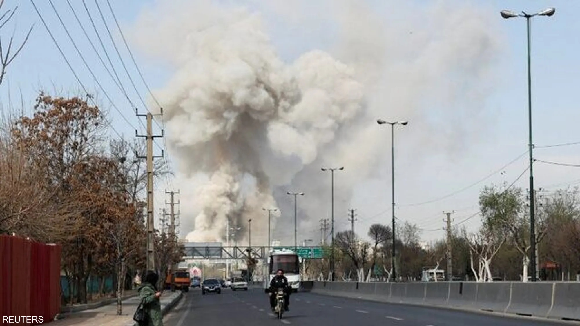 Thick smoke rises into the sky following an explosion in Tehran, as local residents report loud blasts and flashing lights. Emergency sirens could be heard across nearby neighborhoods.