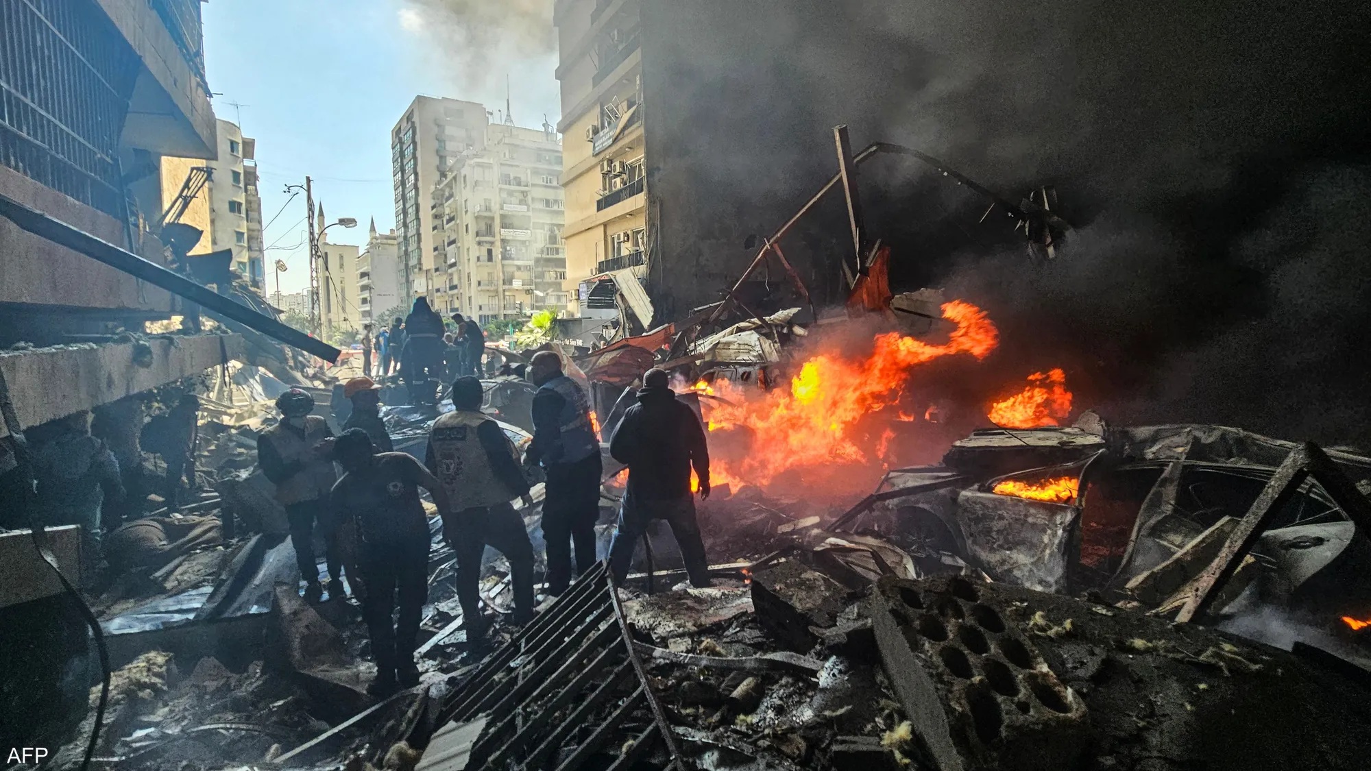 Smoke rises over southern Beirut following Israeli airstrikes on April 8, as emergency crews respond to damaged buildings.