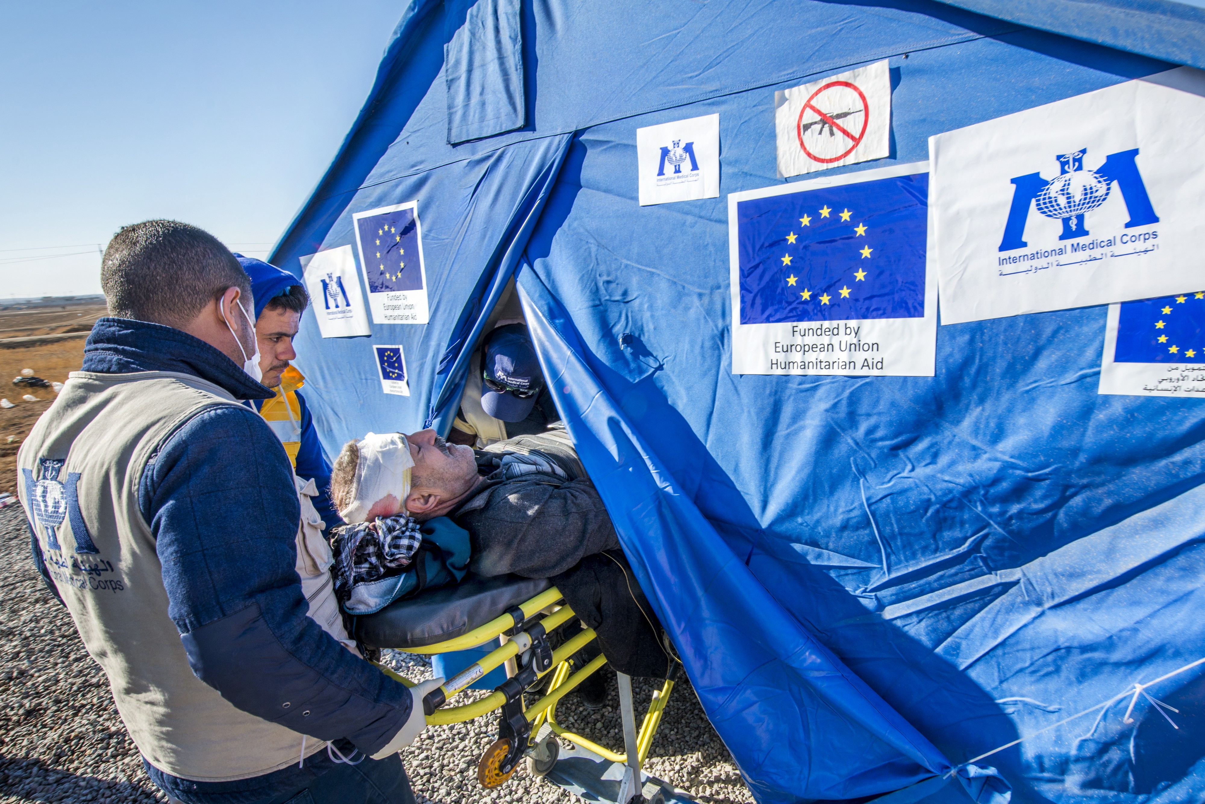 In Mosul, Iraq, a civilian receives life-saving treatment from  International Med. Corps International Med. Corps International Med. Corps International Medical Corps relieves the suffering of those impacted by conflict, natural disaster and disease by delivering medical relief and training.  Followed by 1.9K people  Follow  &mdash; funded by the EU &mdash; after being injured by a car bomb. The purpose of EU humanitarian aid is to protect life and alleviate suffering. Photo &copy; EU/ECHO/Peter Biro