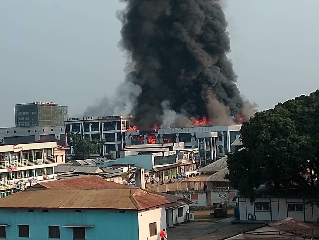 Flames and thick smoke rise from the Le Parisien and Ndayizamba shopping galleries as emergency crews respond to the fire in central Bujumbura, Burundi, on August 21, 2026.
