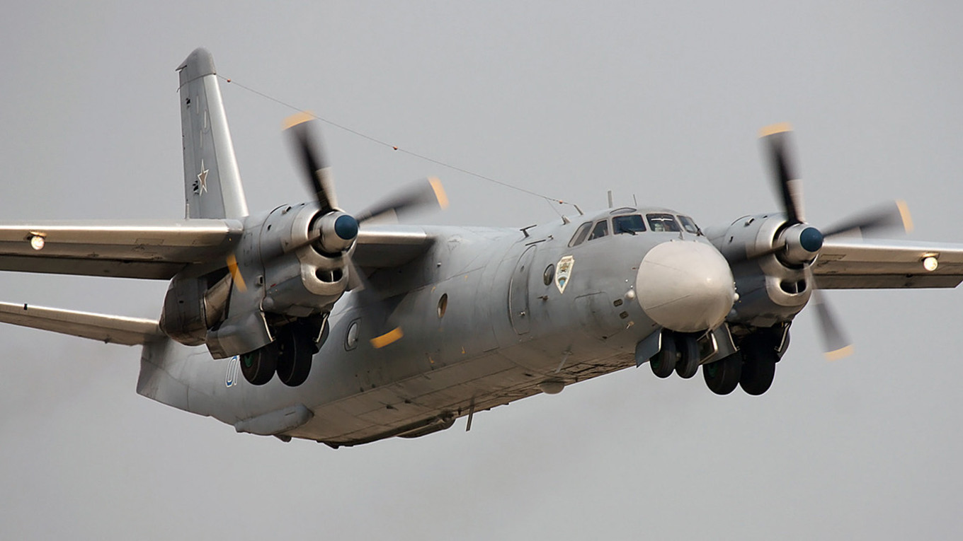 An Antonov An-26 transport aircraft soars through the sky during a routine flight.