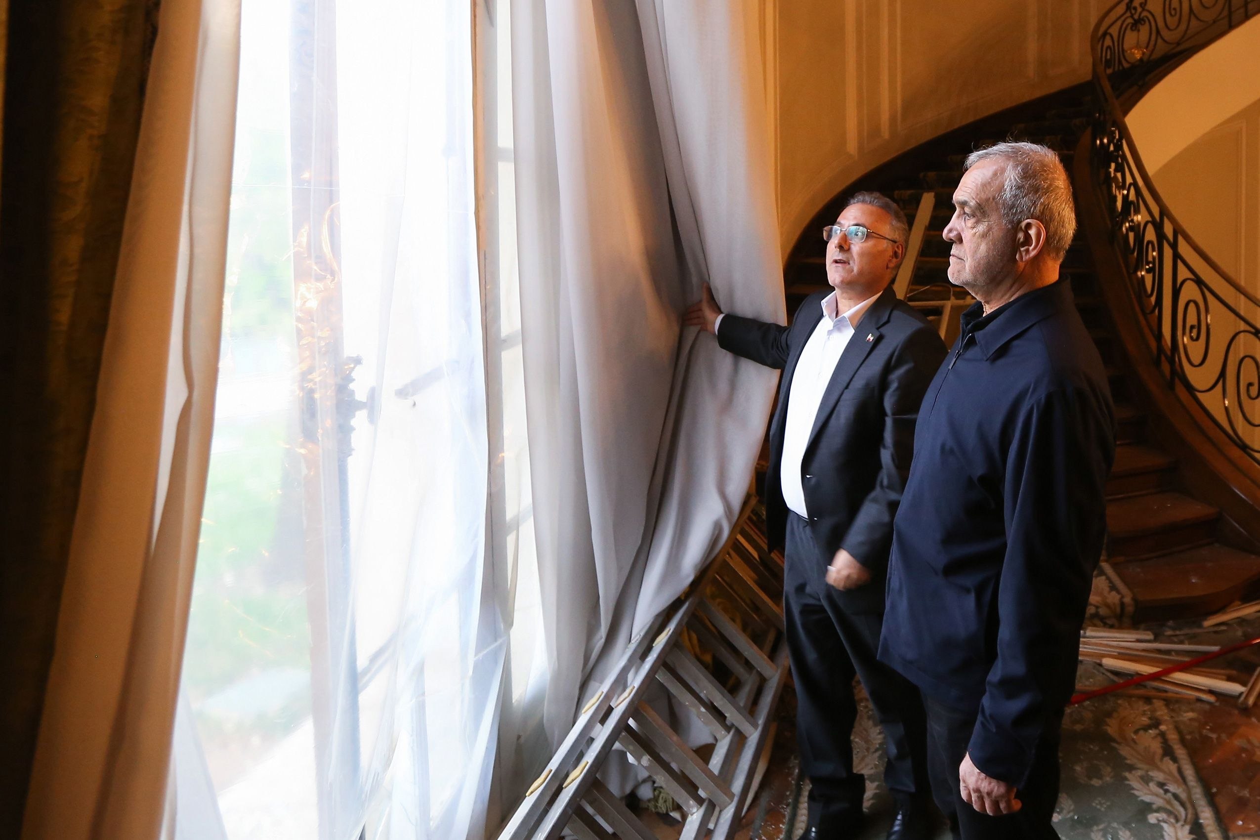 Iranian President Masoud Pezeshkian inspects damaged sections of the Saad Abad cultural and historical complex in northern Tehran following recent military strikes.