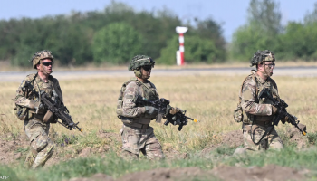 U.S. soldiers patrol a European base, maintaining operational readiness during routine deployment.
