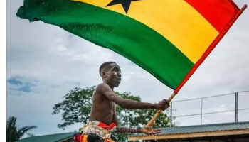 A Ghanaian flag bearer raises the national flag in a public display of identity and unity in Accra.