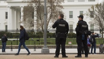 Members of the Secret Service Uniformed Division patrol alongside the security fence around the perimeter of the White House on March 18. | Getty
