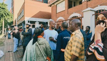 Migrants gather at a temporary shelter in Durban, South Africa, following an evacuation operation amid anti-migrant tensions and rising pressure on foreign nationals in the area.