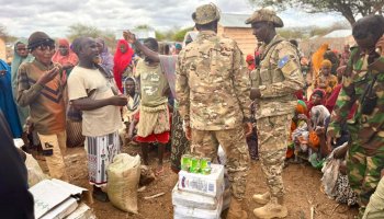 Somali National Army GorGor commandos distribute emergency food aid and water supplies to drought-affected residents in Bay region during a humanitarian relief operation on April 16, 2026.