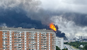 Smoke rises over the Moscow skyline following reported Ukrainian drone strikes, with thick plumes spreading across the city amid heightened tensions and active air defenses.