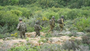 Troops from Israel Defense Forces are positioned near the Lebanon border amid heightened alert levels following renewed clashes, drone interceptions, and evacuation warnings issued to multiple southern villages.