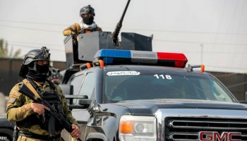 Iraqi security forces stand guard during an operational deployment.