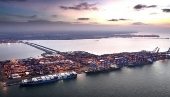 Aerial view of Djibouti's port facilities, where container terminals and cargo cranes operate continuously, reflecting the country's growing role as a key maritime logistics hub on the Red Sea corridor.