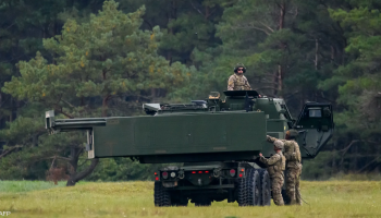 U.S. Marines operate a HIMARS mobile rocket launcher during a live-fire training exercise near Mount Fuji, Japan, firing precision rockets as part of a rapid deployment readiness drill.