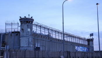 A heavily fortified wall stands outside an Israeli prison facility, marking the perimeter of a secure detention complex designed to restrict movement and maintain controlled confinement of detainees.