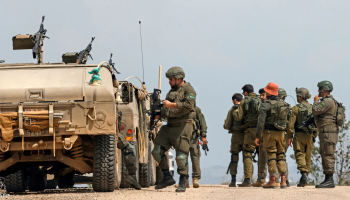 Armed Israeli troops advance through a southern Lebanese area during ongoing military operations near the border.