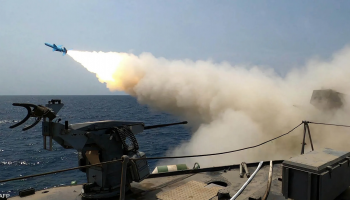 An Iranian Revolutionary Guard Corps naval vessel launches missiles and explosive-laden drones during a reported military operation. (Archived photo)