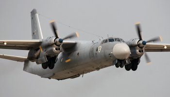 An Antonov An-26 transport aircraft soars through the sky during a routine flight.